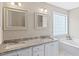 Bathroom features double sinks, granite countertops, and a glass block window at 3208 Wilbon Ridge Dr, Holly Springs, NC 27540