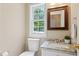 Bathroom with granite vanity top, undermount sink and a window for natural light at 3208 Wilbon Ridge Dr, Holly Springs, NC 27540