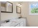 Bathroom features a double vanity with granite countertops and framed mirrors at 3208 Wilbon Ridge Dr, Holly Springs, NC 27540