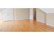 A room with hardwood floors leading to closed, paneled double doors at 3208 Wilbon Ridge Dr, Holly Springs, NC 27540