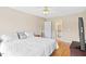 Comfortable bedroom features a ceiling fan, TV, and ensuite bathroom at 3208 Wilbon Ridge Dr, Holly Springs, NC 27540