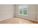 Well lit room with hardwood floors, tan walls and bright double window at 3208 Wilbon Ridge Dr, Holly Springs, NC 27540