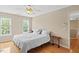 Cozy bedroom with two bright windows and a ceiling fan at 3208 Wilbon Ridge Dr, Holly Springs, NC 27540