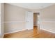Bedroom featuring neutral walls, hardwood floors, and a door that leads to another room at 3208 Wilbon Ridge Dr, Holly Springs, NC 27540