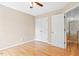 Empty bedroom featuring hardwood floors, ample closet space, and neutral paint at 3208 Wilbon Ridge Dr, Holly Springs, NC 27540