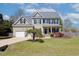 Charming two-story home with a well-maintained lawn and a welcoming front entrance at 3208 Wilbon Ridge Dr, Holly Springs, NC 27540