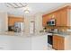 Stylish kitchen featuring a breakfast bar with granite countertops and stainless steel appliances at 3208 Wilbon Ridge Dr, Holly Springs, NC 27540