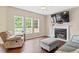 Living room boasts a fireplace and large windows, perfect for relaxation at 3208 Wilbon Ridge Dr, Holly Springs, NC 27540
