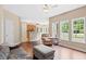 Open living area with hardwood floors, large windows, and a view into the kitchen at 3208 Wilbon Ridge Dr, Holly Springs, NC 27540