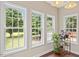 A sunroom with large windows bringing in natural light and an outdoor view at 3208 Wilbon Ridge Dr, Holly Springs, NC 27540