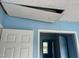 Interior shot featuring an attic access hatch, ceiling, and view into another room with a window at 3213 Sam Usry Rd, Oxford, NC 27565