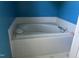 Bathroom showcasing a white tiled tub with fixtures at 3213 Sam Usry Rd, Oxford, NC 27565