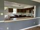 A kitchen view from the dining area looking at light countertops, wooden cabinets, and evidence of needed maintenance at 3213 Sam Usry Rd, Oxford, NC 27565