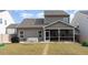 A well-kept backyard with a covered patio and a stepping stone path through the yard and up to the house at 34 Tanglewood Pl, Angier, NC 27501