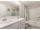 Bright bathroom with double sinks, white cabinetry, and a combined tub/shower at 34 Tanglewood Pl, Angier, NC 27501