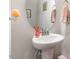 Pedestal sink and oval mirror enhance the powder room's stylish design at 34 Tanglewood Pl, Angier, NC 27501