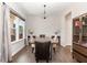 Cozy dining room features hardwood floors, a chandelier, and ample natural light at 34 Tanglewood Pl, Angier, NC 27501
