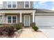 Charming two-story home with a manicured front yard and attached two-car garage at 34 Tanglewood Pl, Angier, NC 27501
