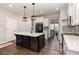 Modern kitchen with a large island, stainless steel appliances, and elegant pendant lighting at 34 Tanglewood Pl, Angier, NC 27501