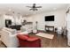 Bright living room with hardwood floors, modern lighting, and an open floor plan at 34 Tanglewood Pl, Angier, NC 27501