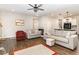 Spacious living room features hardwood floors, ceiling fan, and neutral paint scheme at 34 Tanglewood Pl, Angier, NC 27501