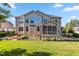 Large backyard featuring an expansive lawn, patio area, and screened-in porch at 3404 Mount Pisgah Way, Cary, NC 27519