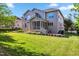Backyard with a lush green lawn, screened-in porch, and patio area perfect for entertaining at 3404 Mount Pisgah Way, Cary, NC 27519