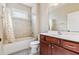 Well-lit bathroom with a shower-tub combo, updated vanity, and decorative tile accents at 3404 Mount Pisgah Way, Cary, NC 27519