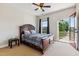 Cozy bedroom featuring a decorative wood-framed bed and access to a private outdoor balcony at 3404 Mount Pisgah Way, Cary, NC 27519