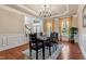 Formal dining room featuring a decorative tray ceiling, modern chandelier, and large windows at 3404 Mount Pisgah Way, Cary, NC 27519
