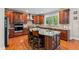 A kitchen with cherry wood cabinets, granite countertops, stainless appliances and hardwood floors at 3404 Mount Pisgah Way, Cary, NC 27519
