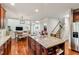 A kitchen island with granite countertops sits central to the dinette set and staircase at 3404 Mount Pisgah Way, Cary, NC 27519