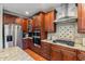 A kitchen featuring stainless steel appliances, wooden cabinets and granite countertops at 3404 Mount Pisgah Way, Cary, NC 27519