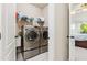 Modern laundry room equipped with stainless steel washer and dryer at 3404 Mount Pisgah Way, Cary, NC 27519