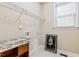 A laundry room with white tile flooring and window at 3404 Mount Pisgah Way, Cary, NC 27519