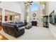Spacious living room featuring a fireplace, large windows, and comfortable leather seating at 3404 Mount Pisgah Way, Cary, NC 27519