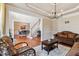 Formal living room showcasing elegant furniture, neutral paint and views of other living spaces at 3404 Mount Pisgah Way, Cary, NC 27519