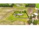 Single story home featuring lush landscaping, circle driveway, and mature trees in a sprawling yard at 360 Country Way, Sanford, NC 27332