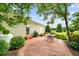 Back patio area features an outdoor seating area on brick pavers and mature landscaping at 360 Country Way, Sanford, NC 27332