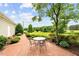 Back patio area features an outdoor seating area on brick pavers and mature landscaping at 360 Country Way, Sanford, NC 27332