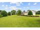 Spacious backyard with manicured lawn, landscaping and a detached garage at 360 Country Way, Sanford, NC 27332