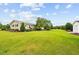 Large backyard featuring mature landscaping, a small shed, and a well-maintained lawn at 360 Country Way, Sanford, NC 27332
