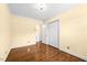 This bedroom features hardwood floors, neutral walls, a ceiling light, and a large closet for storage at 360 Country Way, Sanford, NC 27332