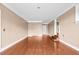 Large bonus room with neutral colored walls and hardwood flooring ready for your personal touches at 360 Country Way, Sanford, NC 27332