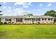 Charming single story home featuring a beautiful front lawn, mature landscaping and inviting front porch at 360 Country Way, Sanford, NC 27332