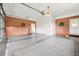 The large three car garage has brick accent walls, multiple entrances, and a ceiling fan at 360 Country Way, Sanford, NC 27332