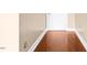 Hallway with hardwood floors, neutral walls, and classic white trim at 360 Country Way, Sanford, NC 27332