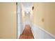 Hallway boasts pristine woodwork, neutral walls, chandelier and hardwood flooring at 360 Country Way, Sanford, NC 27332