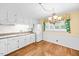 Bright kitchen with granite countertops, white cabinetry, and stainless steel refrigerator at 360 Country Way, Sanford, NC 27332