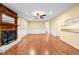 Bright living room features hardwood floors, a ceiling fan and fireplace with mantle at 360 Country Way, Sanford, NC 27332